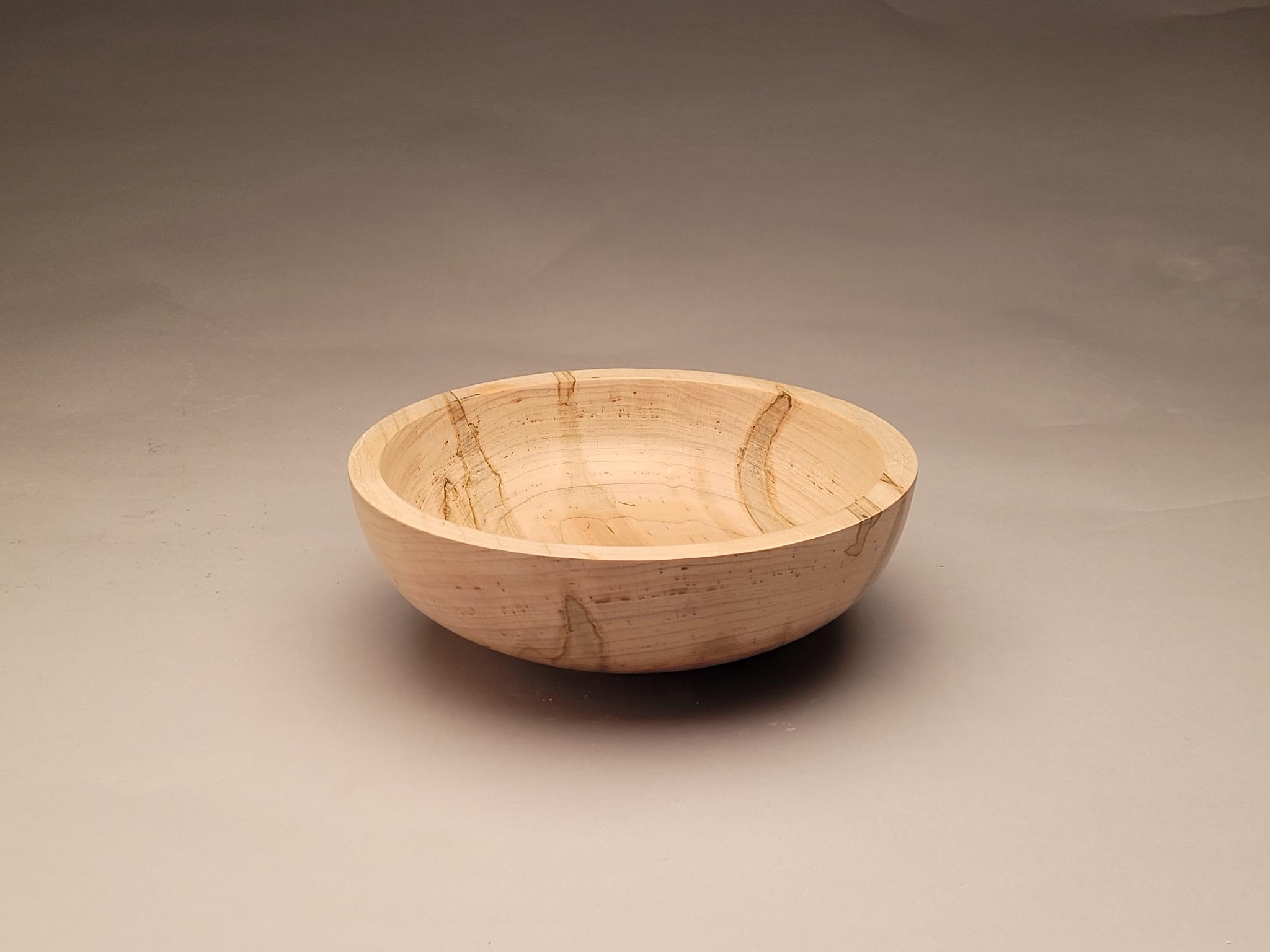 Pale wood-turned bowl with visible natural cracks